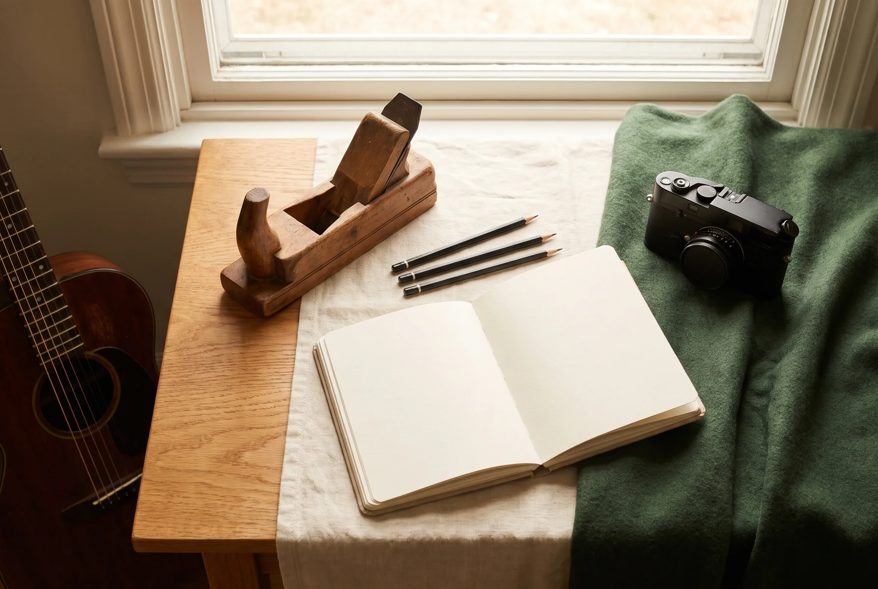 An inviting workspace with creative materials, a notebook and everyday tools